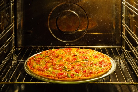 Homemade pepperoni pizza in ovenの写真素材