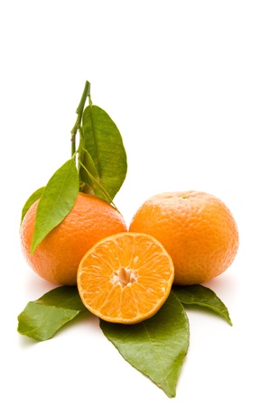 fresh bio mandarins on green leafs isolated on a white backgroundの写真素材