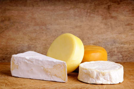 still life composition with cheese on a vintage wooden backgroundの写真素材