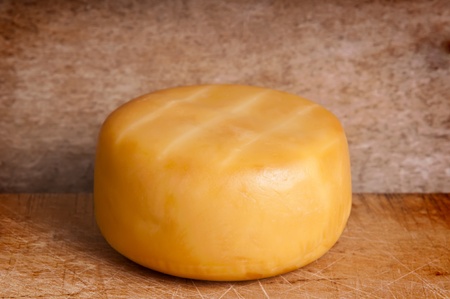 traditional smoked cheese on a wooden backgroundの写真素材