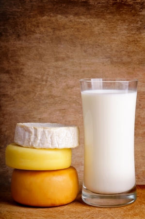 still life composition with cheese and milk on a wooden vintage backgroundの写真素材