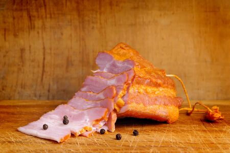 close up of sliced smoked ham on a wooden backgroundの写真素材