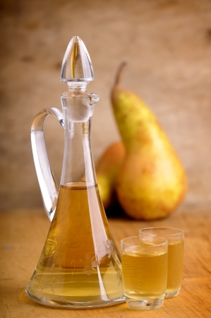 fruit brandy with pears on a wooden backgroundの写真素材