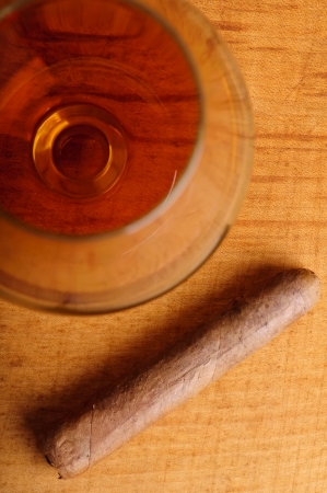 top view on glass of cognac and cigarの写真素材