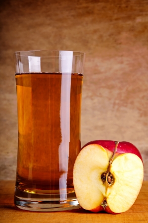 fresh organic apple juice and apples on a vintage wooden backgroundの写真素材