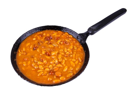 traditional homemade meal with beans and sausages in a pan isolated on a white backgroundの写真素材