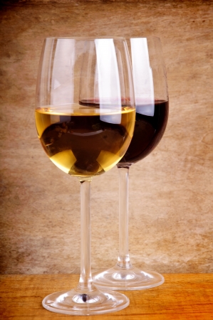 gass of red and white wine on a vintage wooden backgroundの写真素材