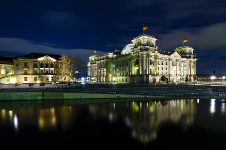 reichtstag (bundestag) with reflection in spree river in berlin, germany at nightのeditorial素材