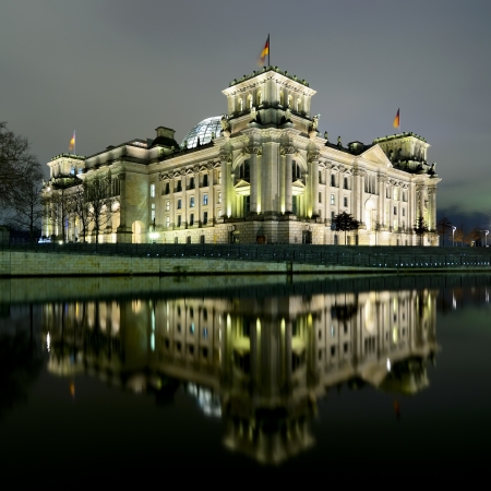 reichstag (bundestag) with reflection in spree river in berlin, germany at nightのeditorial素材