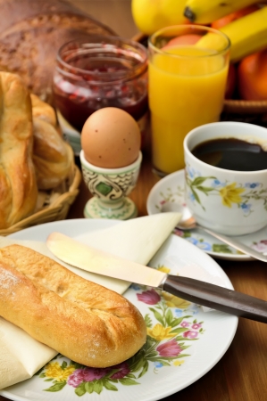 traditional breakfast with bread, egg, cup of coffe, jam, orange juice and fruitsの写真素材