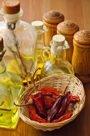 dried chili with olive oil and condiments on a wooden backgroundの写真素材