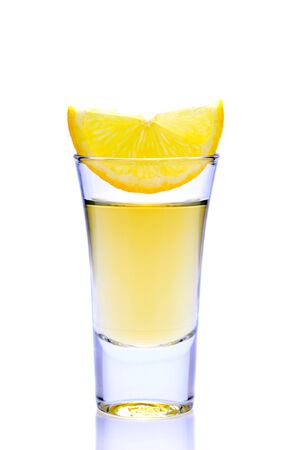tequila shot with lemon isolated on white backgroundの写真素材