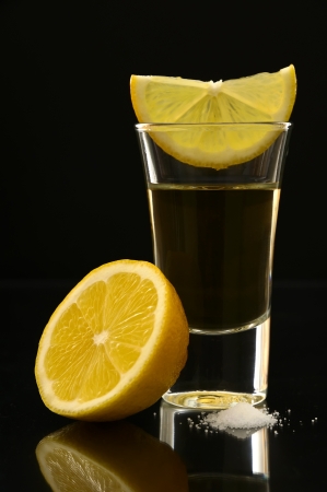 tequila shot with lemon and salt on a black backgroundの写真素材