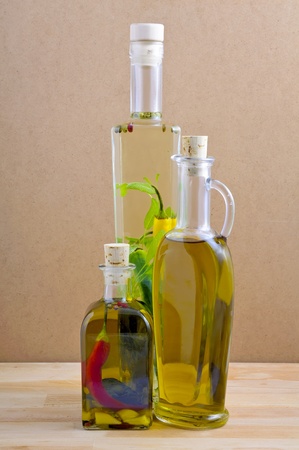 bottles of herbal and olive oil on a wooden backgroundの写真素材
