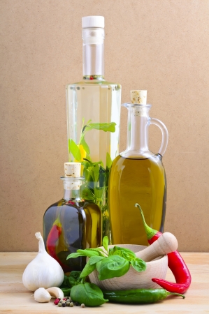 food ingredients with herbal oil, herbs and spices on a wooden backgroundの写真素材