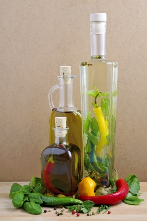 infused olive oil and herbs and ingredients on a wooden backgroundの写真素材