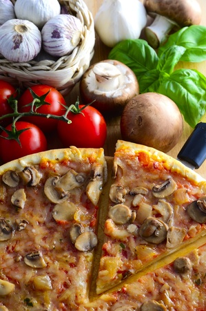 traditional italian pizza with mushrooms, tomatoes, garlic and basilの写真素材