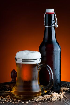 still life with glass and bottle of fresh beerの写真素材