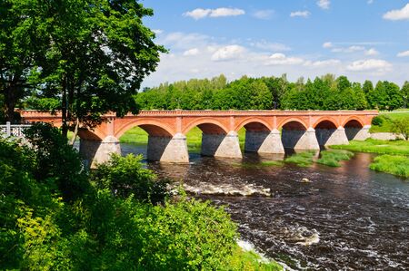 brick bridge over venta river in kuldiga, latviaの写真素材