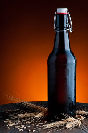 still life with fresh cool beer bottle and wheatの写真素材