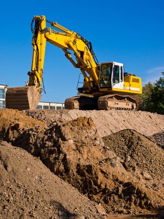 excavator machine on pile of earthの写真素材