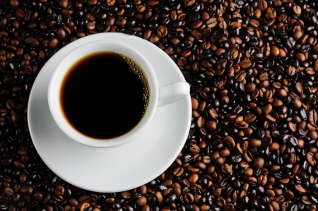 still life with fresh cup of coffee and beansの写真素材