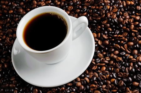 still life with fresh cup of coffee and beansの写真素材