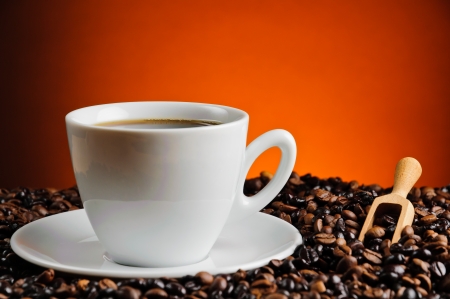 fresh cup of coffee with coffee beansの写真素材