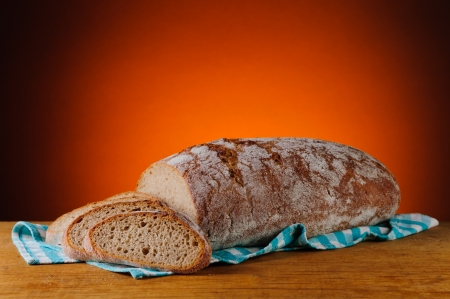 still life with fresh sliced bread on a wooden tableの写真素材