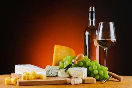 still life with white wine, cheese and grapesの写真素材