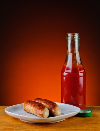 still life with grilled sausages and ketchupの写真素材