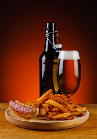 grilled sausage, french fries and fresh beerの写真素材