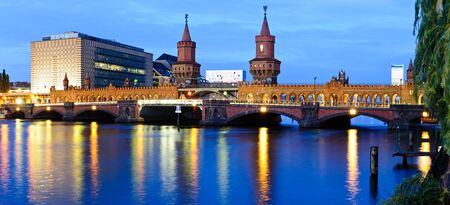 panorama with oberbaum bridge in berlin, germany, at nightの写真素材