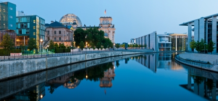 panorama with reichstagufer and spree river in berlin, germany at nightの写真素材