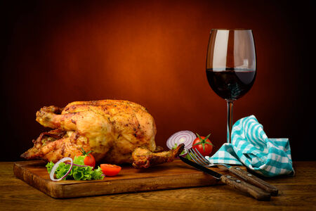 still life with traditional roasted chicken and red wineの写真素材