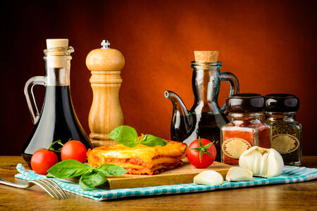 traditional lasagne with food ingredients, herbs and spicesの写真素材