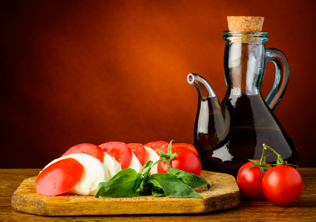 caprese salad with mozzarella, basil, olive oil and tomatoesの写真素材