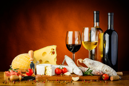 still life with traditional cheese, sausages food and wineの写真素材