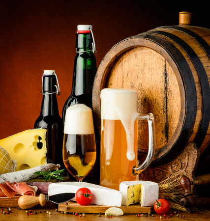 still life with beer traditional food and wooden barrelの写真素材