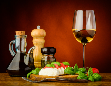 caprese salad with mozzarella, basil, tomatoes and white wineの写真素材