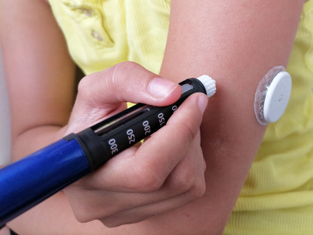 Girl with diabetes injects insulin with insulin pen in her arm. On the arm is also placed white...