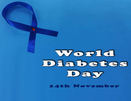 World diabetes day, 14  november. The blue ribbon with red blood drop isolated on blue background. Diabetes symbols. Copy space for your text on the right side.の写真素材