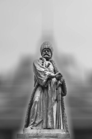 Black and white statue of a king or feudal lord with blurred backgroundの写真素材