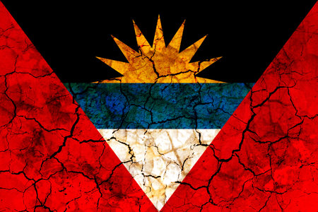antigua and barbuda country flag symbol painted on a cracked grungy wall. Concept of drought, hardship, no rain or economic crysisの写真素材
