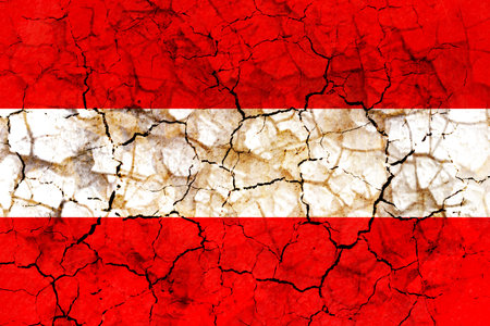 austria country flag symbol painted on a cracked grungy wall. Concept of drought, hardship, no rain or economic crysisの写真素材