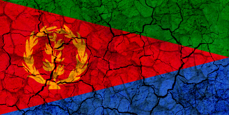 eritrea country flag symbol painted on a cracked grungy wall. Concept of drought, hardship, no rain or economic crysisの写真素材