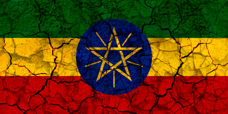 ethiopia country flag symbol painted on a cracked grungy wall. Concept of drought, hardship, no rain or economic crysisの写真素材