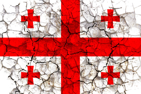 georgia country flag symbol painted on a cracked grungy wall. Concept of drought, hardship, no rain or economic crysisの写真素材
