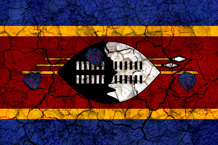 swaziland country flag symbol painted on a cracked grungy wall. Concept of drought, hardship, no rain or economic crisisの写真素材