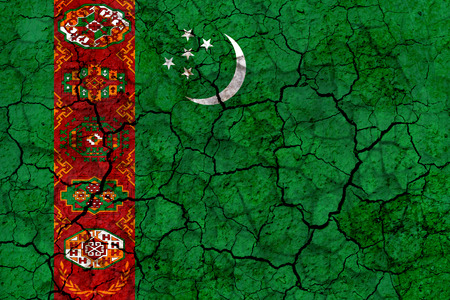 turkmenistan country flag symbol painted on a cracked grungy wall. Concept of drought, hardship, no rain or economic crisisの写真素材